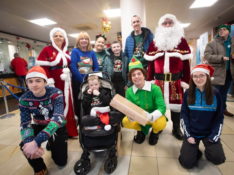 Santa, Mrs. Claus and Little Helpers pictured with one of the families at 'Santa Saturday'. (Photos: Jim McCafferty Photography)