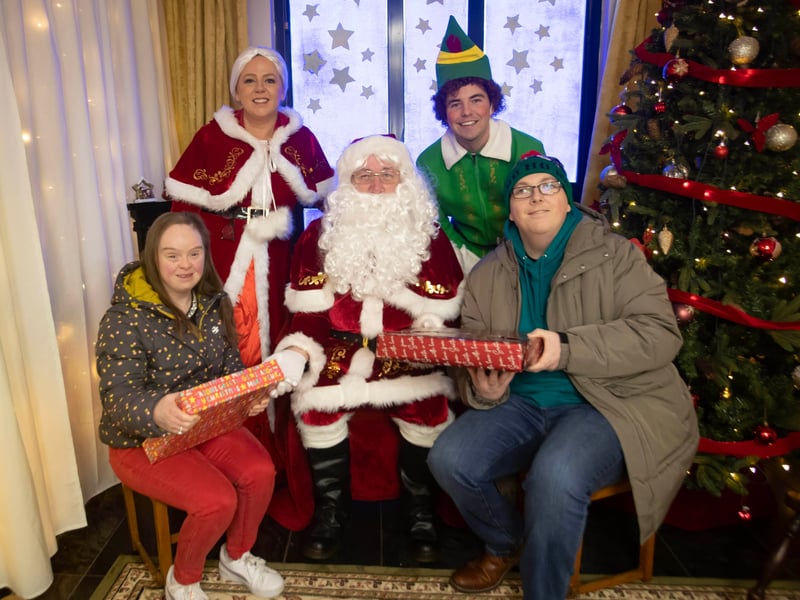 Amanda Dillon and Donal Donnelly pose with Santa for a picture at 'Santa Saturday' in Derry Credit Union.