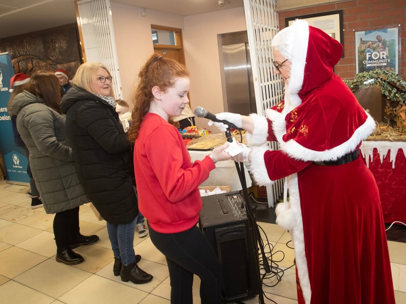 Ten years-old St. Eugene's PS pupil Sophie Cooley sings a Christmas carol with Mrs. Claus.