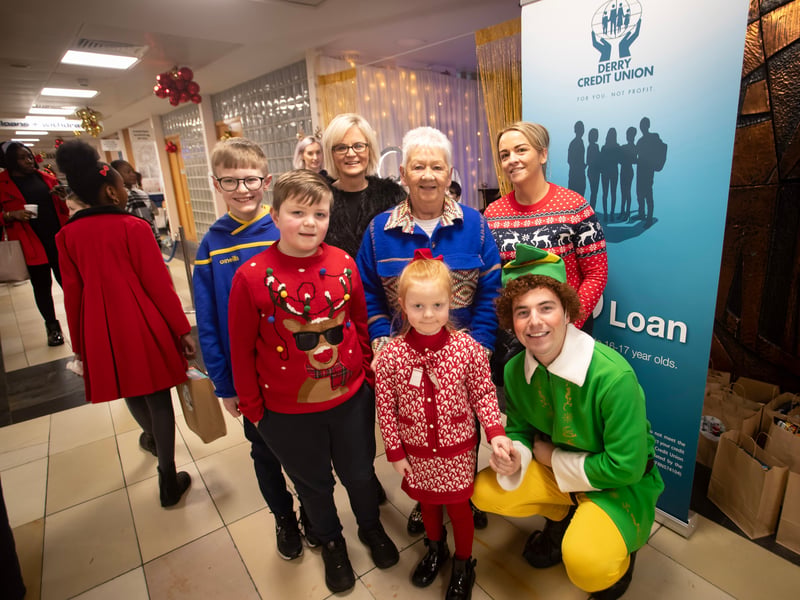 Happy families pose for a photo during the Derry Credit Union's 'Santa Saturday'.