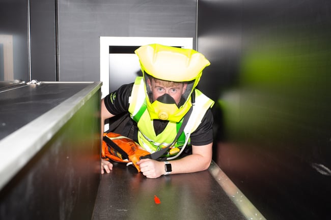Cormac Delaney demonstrating inside the new confined space mobile training unit.