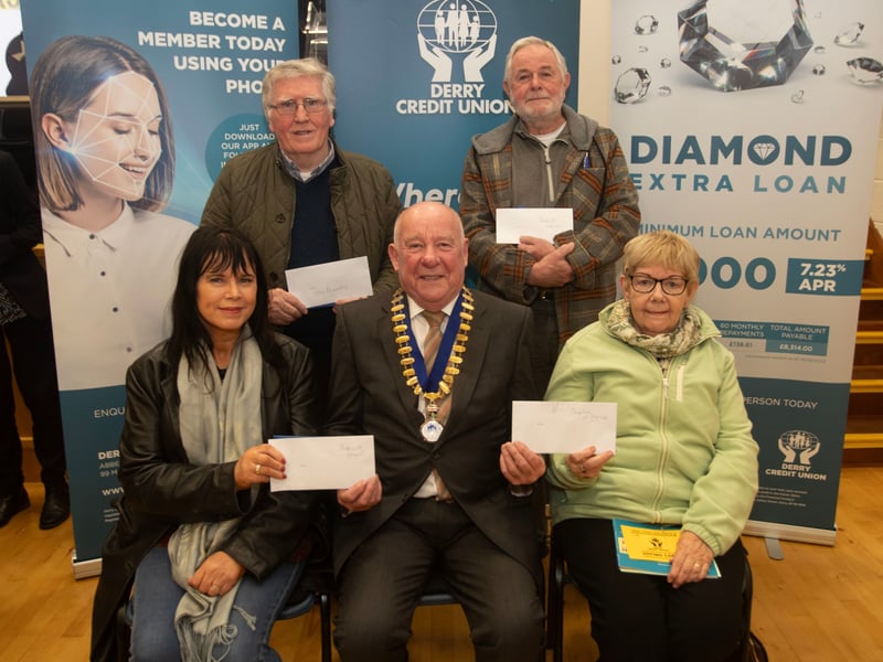 Derry Credit Union president Colm McCauley presenting the £250 prizewinners at Monday night's AGM. Front from left, Patricia Grant, Sheila Hynes, and at back, John Kennedy and Patrick Meenan.