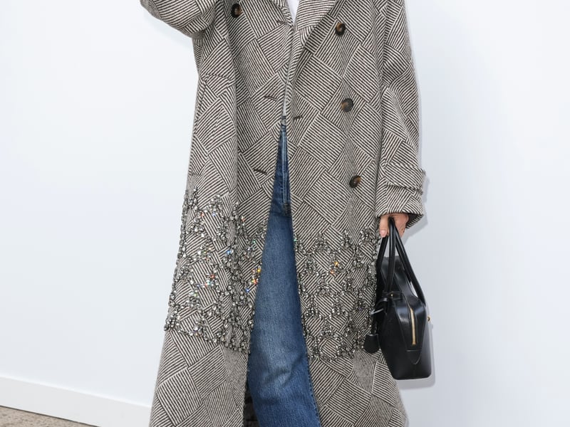 Sharapova, 37, wore a herringbone woollen overcoat with crystal detailing, paired with jeans and black loafers, matching her black Stella Ryder shoulder bag, which retails now for £1,175.