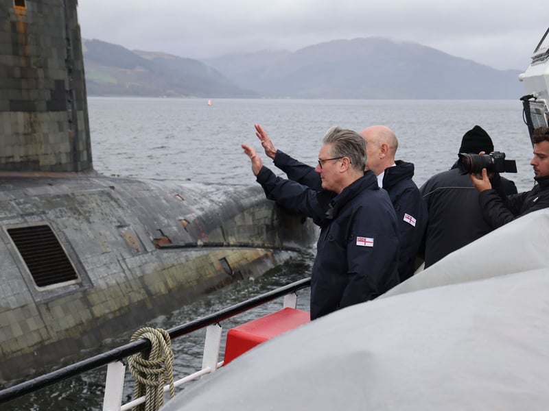 Prime Minister Keir Starmer and Defence Secretary John Healey waving to the casing party.