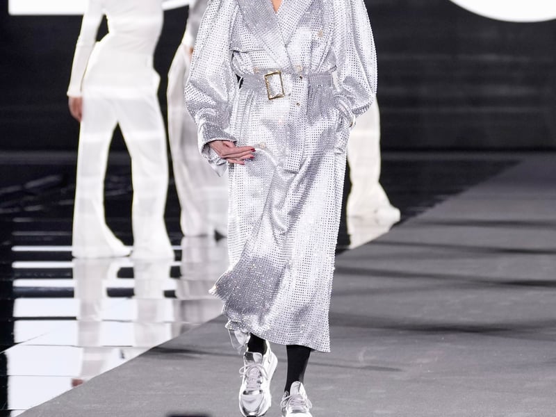 Fonda, 86, wore a shimmering silver trench to match her bombshell curls. The actor paired the glamourous look with box fresh metallic trainers.