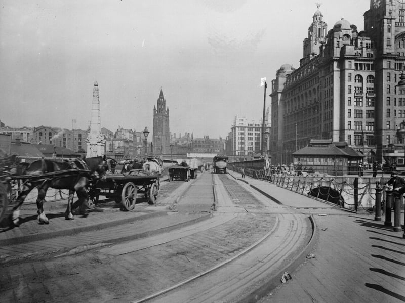 Horse-drawn carts bring the goods from Liverpool Docks into the city centre in around 1920