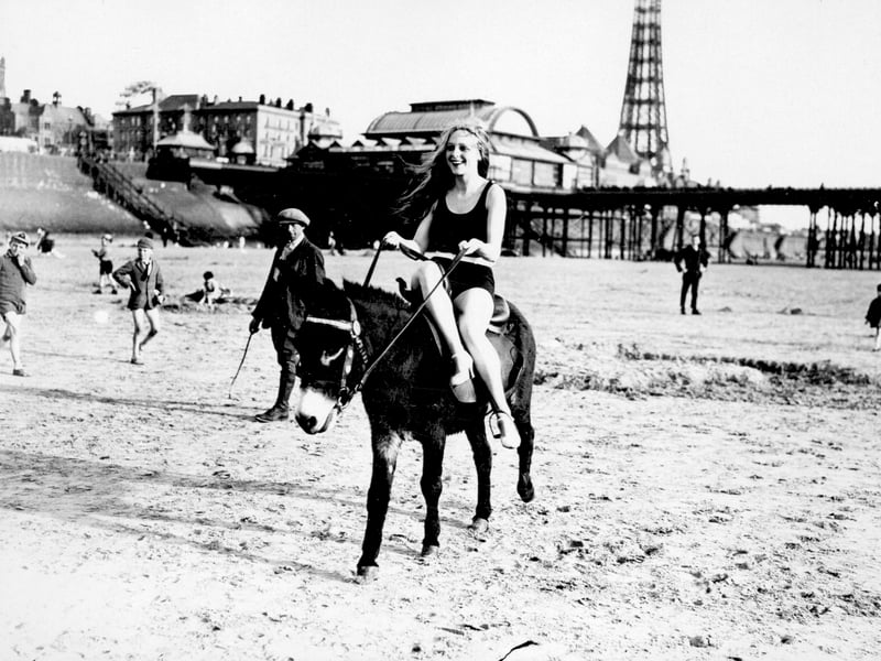 Film actress Evelyn Holt riding a donkey on Blackpool beach, during a break between shots for a film, in August 1928