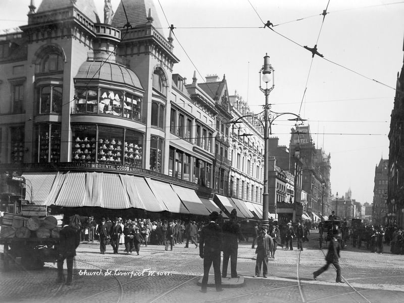 A bustling Church Street, Liverpool, pictured sometime between 1890 and 1910. On the corner is Bunney's General Store, which has many items advertised in its windows, including washing jugs and basins.