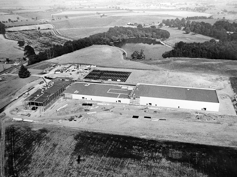 The Hitachi-Maxell video tape factory is seen under construction at Apley Park, in October 1983, marking a period of industrial growth in the area. Apley Pool, a popular local fishing spot, can be seen behind the developing site, offering a contrast between industry and leisure in the landscape at the time.