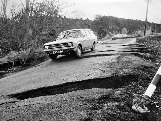Jackfield road is shown in January 1983 following another dramatic episode of subsidence, with the surface of Salthouse Road splitting and collapsing. Council workers moved in quickly to patch up the damage after the incident, which left the area looking as though it had been hit by repeated “earthquake” activity. The scene, captured shortly after the event, features a Morris Marina estate car in the foreground, highlighting the everyday disruption caused by ongoing ground instability in the village.