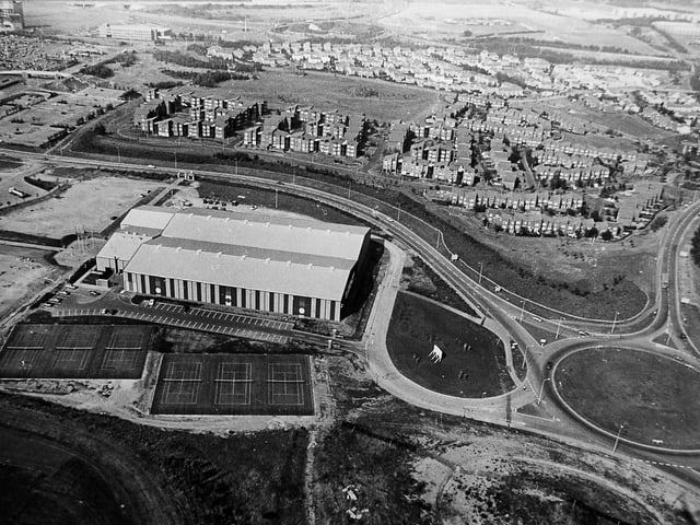 Telford’s Racquet Centre is captured in this aerial view from 1983, showing the newly developed West Midlands Tennis and Racquet Centre at Telford Centre. Hollinswood housing estate can be seen at the top of the image, offering a glimpse of the surrounding town landscape at the time.