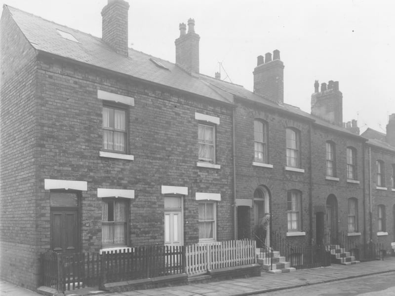 Mosdale Street in November 1960 Image shows Leek Street on the left. A man in a jacket and flat cap stands on the steps of number 46.