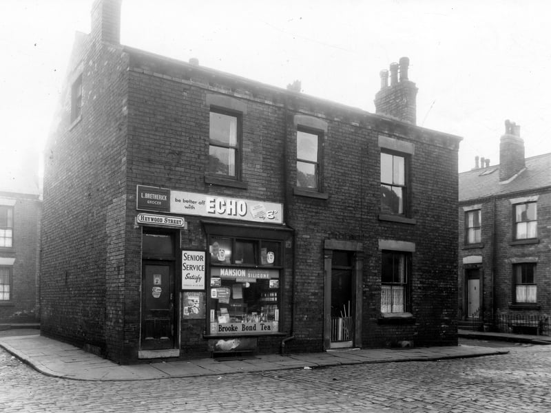 On the left is Hulland Street with numbers 1 and 3 Heywood Street in the centre of the Image and Heywood Place is on the right. At number 1 Heywood Street is the L. Bretherick grocery. Pictured in December 1960.