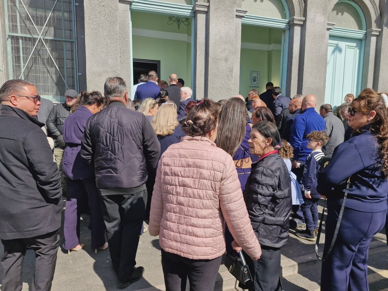 The church begins to fill after the coffin was taken in