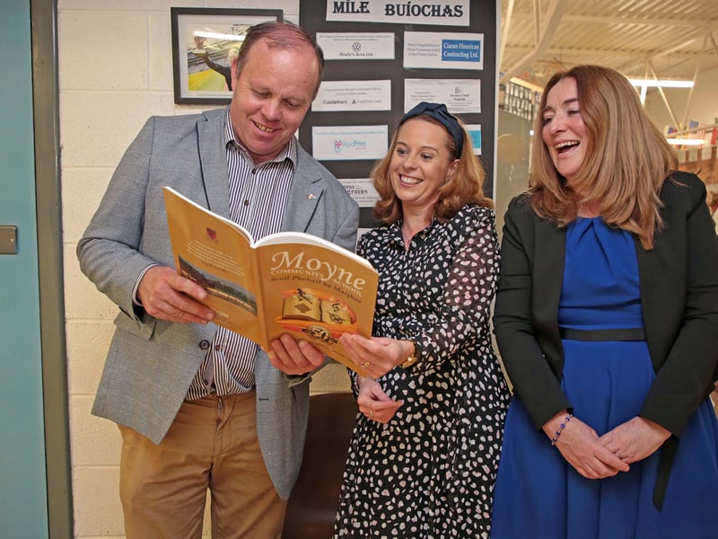 Caption: Cllr Paraic Brady, Rose Keogh and Rose Hennigan flicking through the pages of the Moyne CS Golden Jubilee book