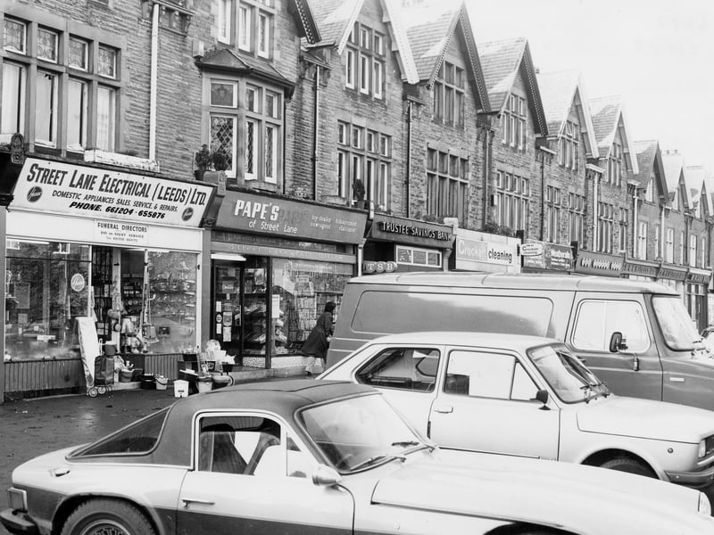 A parade of shops on Street Lane between Sutherland Avenue and Shaftesbury Avenue. Shops visible include Street Lane Electrical (Leeds) Ltd, a Hoover advertising domestic appliances, sales, service and repair shop. This business later moved to premises on Lidgett Lane. Pictured in November 1979.