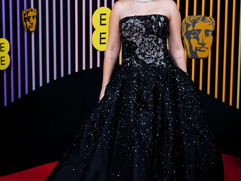 Star of How To Have Sex, Mia McKenna-Bruce, is one of the nominees for this year’s Rising Star Award, and for the occasion she chose a classic black sequinned strapless gown with silver floral accents from American brand Carolina Herrera, paired with a statement Cartier necklace.
