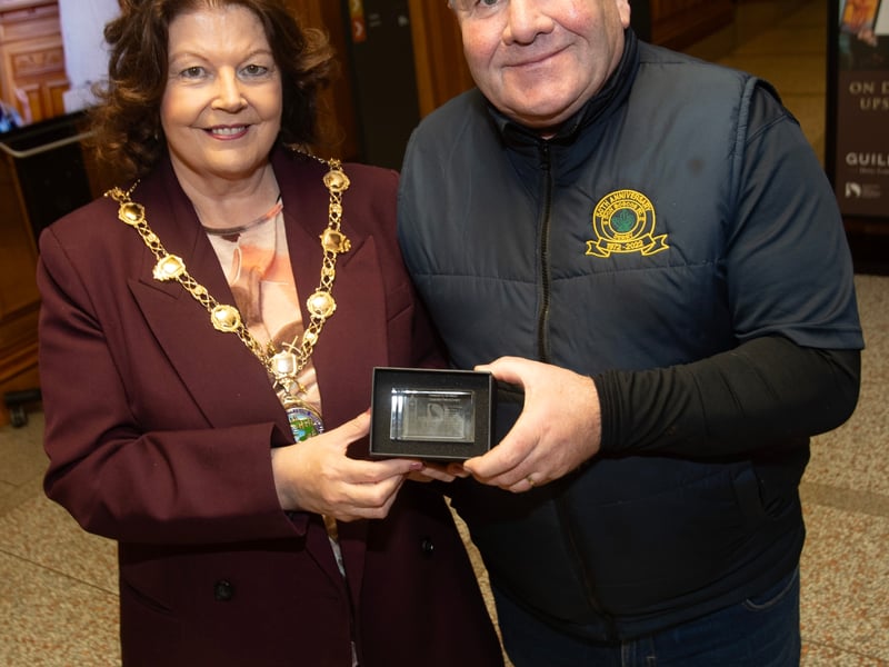 Don Boscos FC u-13 coach Vinny Brady receiving a special memento from the Mayor, Patricia Logue on Monday evening to mark Vinny's secondment for a year from Don Bosco's to look after the Foyle Cup team.