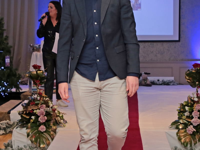 Caption: Mark Hughes struts his stuff on the catwalk