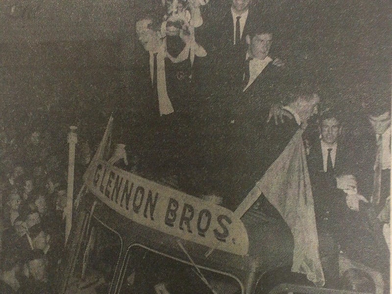 Caption: 1966 National Football League Final ‘Proper’ Homecoming: “The Boys of the Blue and Gold”. From a Glennon Brothers truck, Sean Donnelly, Sean Murray and captain Brendan Barden display the National League Trophy as the triumphant Longford team were greeted in Longford town on Monday, October 10, 1966 following their 1-18 to 0-17 aggregate win over New York in the NFL Final ‘Proper’. Other players in view are John Donlon, Larry Gillen and Peter Sheridan. 