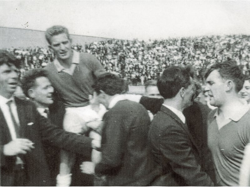 Caption: 1968 Leinster Senior Football Championship Final: Sean Donnelly, scorer of 2-1, in Longford's 3-9 to 1-4 victory over Laois the Leinster SFC, is carried shoulder high off the Croke Park pitch by delighted supporters. On the right of photograph is Brendan Gilmore. Longford, incidentally, wore colours similar to Meath, green with gold trim, on that occasion to avoid a clash of jerseys with Laois.