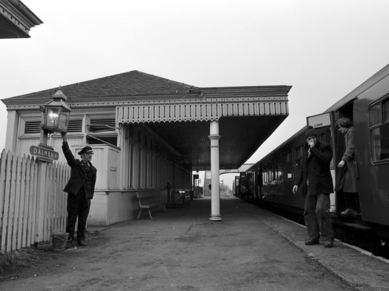 Dalmeny railway station, near South Queensferry, still had functioning gas lamps in late 1978. Passengers are seen here arriving at the station as a member of staff lights the lamps.