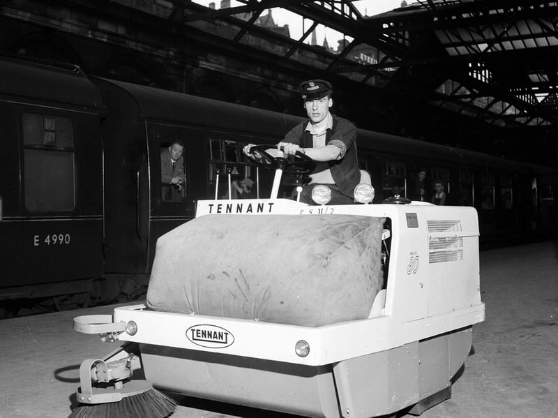 Railwayman Terry Reid operates a new mechanical sweeper at Waverley Station in September 1962