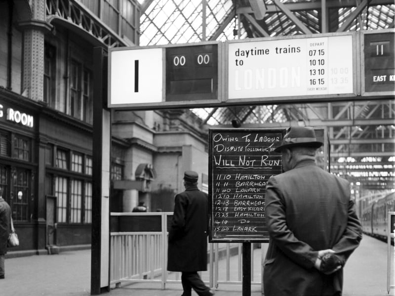 A passenger checks the non-availability of trains on the notice board at Glasgow Central railway station during the strike of June 1967