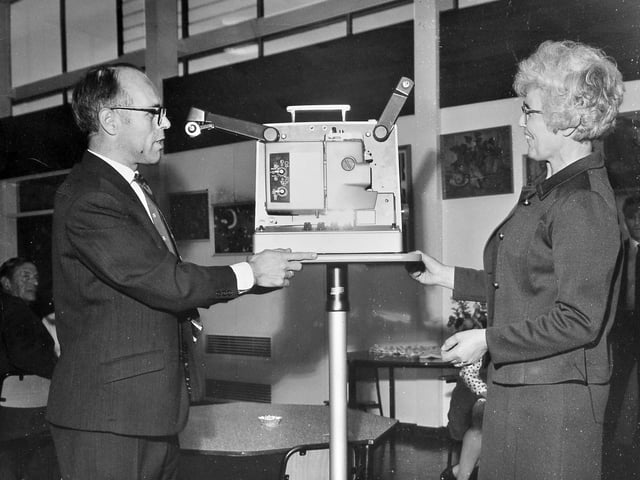 A presentation at Dothill Junior School as the chairman of the parent-teacher association, Mr C Henderson, hands over a film projector and accessories worth nearly £400. The equipment was presented to headmistress Mrs J E Beard during a school social evening on July 3, 1970.