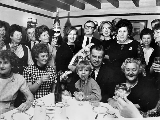 Members of the Town House staff gather at the Red Lion Hotel on Holyhead Road for a farewell party held for proprietors Mr and Mrs Terry Heath. Pictured at the centre, the couple were preparing to leave the district following the event, which took place on October 13, 1970.
