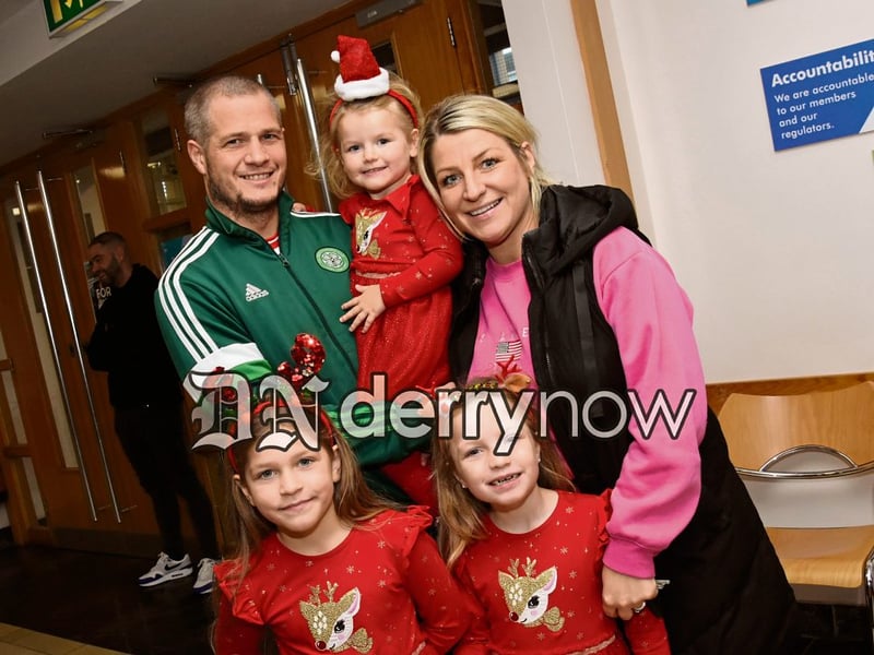 The Saunders family queue up to meet Santa