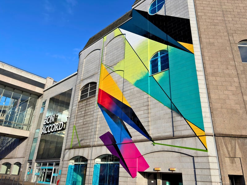 With a distinct visual style, abstract artist Remi Rough has transformed the George Street entrance of the Bon Accord Centre with his large mural. 
