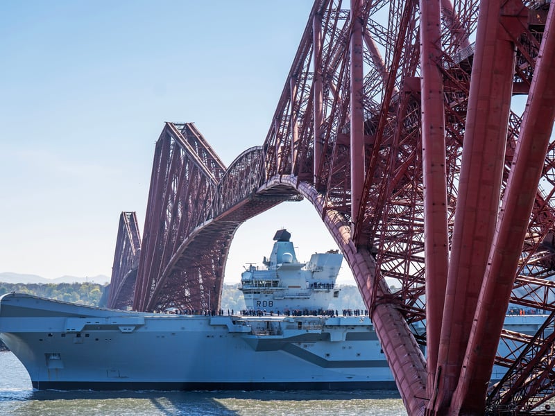 HMS Queen Elizabeth passes under the Forth Bridge heading out to sea after leaving Rosyth, Fife, following an extended maintenance period.
Picture: Jane Barlow/PA Wire