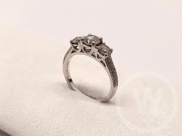 Diamond Ring, Three Stone Mounted In Platinum Ring, One Round Brilliant Cut Diamond Centre with Two Round Brilliant Cut Diamond Sides Secured in Tapered Four Claw Collets, Uniform Shoulder each Pave Set with 27 Round Brilliant Cut Diamonds, Total estimated Carat: 1.33 carat, Gross Weight: 4.08g, Box: No, Additional Information: One Diamond Missing From Shoulder