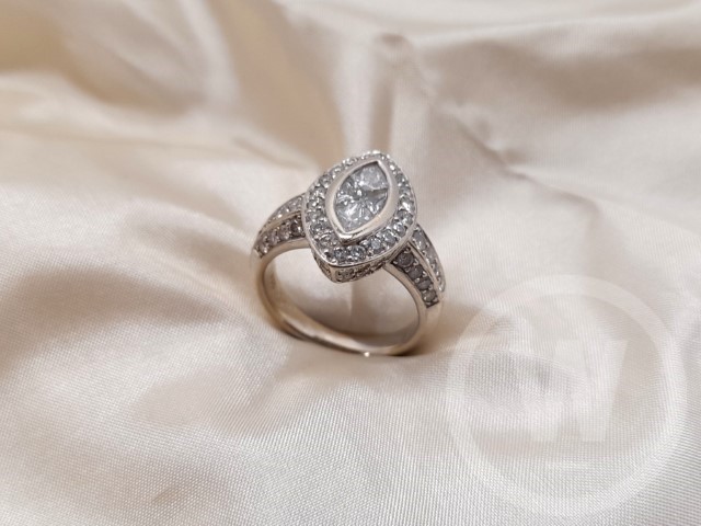Diamond Ring, Diamond Set in 18 Carat Gold Ring, Kite Shaped Diamond Chanel Set to the Centre Surrounded by 20 Set Round Brilliant Cut Diamonds, Size: EU 53/ UK M, Gross Weight: 7.66g, Box: No, Additional Information: One Diamond Missing