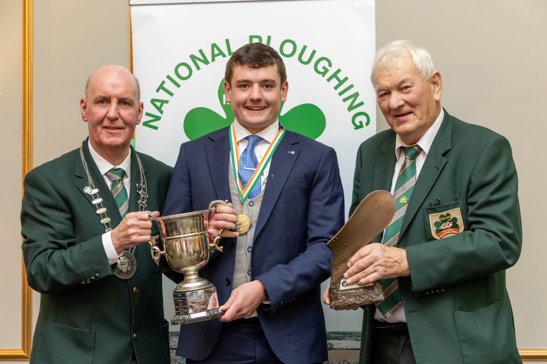 Steve Tracey from Carlow is presented with the Michael O’Connor cup, NPA trophy and gold medal for Under 28 conventional - senior by NPA president James Sutton and chairman Mick Mahon at the National Ploughing Association awards and banquet in Portlaoise. Picture: Alf Harvey