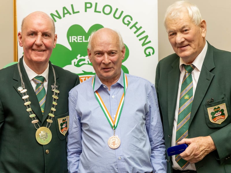 Richard Keegan from Carlow is presented with a bronze medal for 3 Furrow Conventional Senior by NPA president James Sutton and chairman Mick Mahon at the National Ploughing Association awards and banquet in Portlaoise. Picture: Alf Harvey