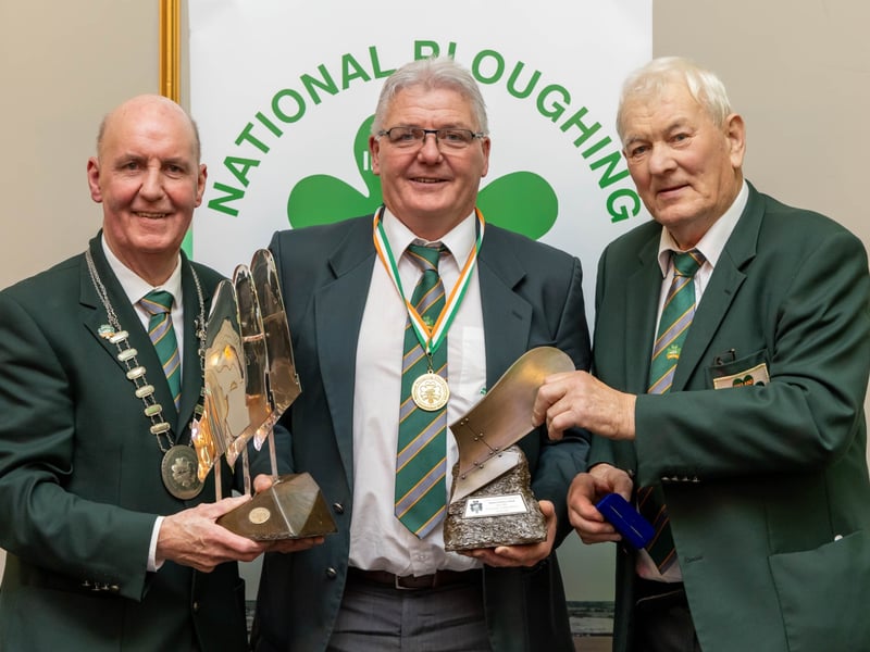 Eamonn Tracey from Carlow is presented with the Esso Supreme Trophy, NPA Trophy and gold medal for Senior Conventional by NPA president James Sutton and chairman Mick Mahon at the National Ploughing Association awards and banquet in Portlaoise. Picture: Alf Harvey