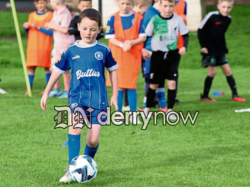 This young boy steadies the ball before taking a shot at the net.