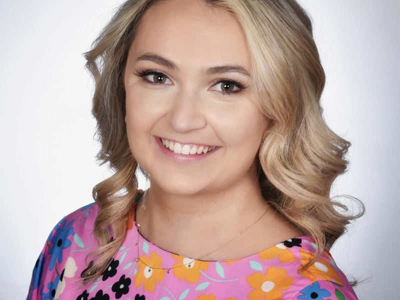 Cork Rose Kate Shaughnessy Hello from the Rebel County Cork. My name is Kate and I am delighted to be representing Cork in this year’s Rose Of Tralee International Festival. I am 25 years old and from Ballincollig. I graduated from University College Cork in 2020 with a Bachelor of Social Science Degree and I now work as the Care Coordinator in the lovely Norwood Grange Nursing Home in Ballinora. While my job has lots of variety, my main role is making sure that all the residents in Norwood Grange feel at home. I have worked in elderly care for the last 6 years and absolutely adore what I do, and feel it a great privilege to be part of what can be a very hard, yet very special time, for both the residents and their families. I was honoured to receive a Mowlam Healthcare Recognition Award in 2021 for my work keeping residents and their families engaged during the COVID19 pandemic. My parents are both from Tralee originally, so the Festival has always been a part of my life growing up and it has been a dream of mine to represent Cork. I am so looking forward to meeting you all in August.