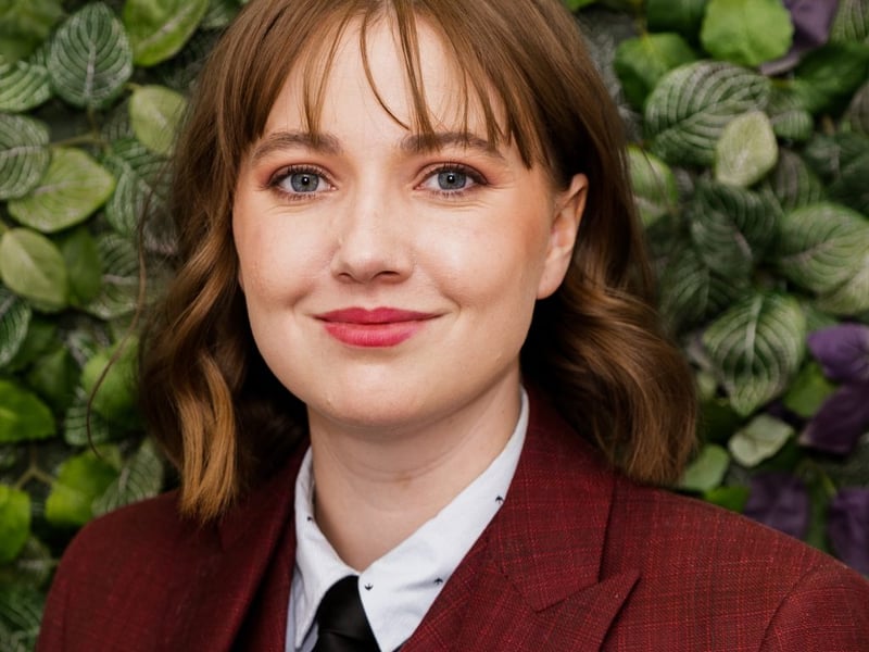South Australia Rose Charlotte Burton Hi! I’m Charlotte, I’m 27 years old and I’m from Adelaide, South Australia, where I live on Kaurna land. I am a multi-disciplinary artist, working primarily in video content creation. I work at The Growing Space, a disability-focused company where I produce videos aimed at empowering disabled people. As a disabled woman myself, being able to engage with my community in this way is incredibly rewarding. I also am a founding member of DIDA (Disability, Illness and Divergence Association) a group dedicated to supporting disabled and chronically ill students in higher education through peer support. In my free time, I dance (Irish, Tap and Contemporary), play soccer for the Adelaide Jaguars, and paint. I take great pride in my Irish heritage, which comes from my parents who emigrated to Australia from Ireland in the 1980s. My Mother hails from Youghal, Co. Cork and my Father is from New Ross, Co. Wexford. I grew up with a profound appreciation of Irish culture, particularly the language and music. To be a part of the Festival is an amazing opportunity for me to submerge myself in my heritage and reconnect with Ireland.