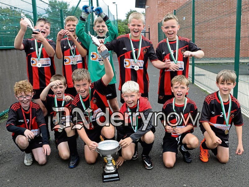 Phoenix Athletic players celebrating winning the Padraig Barton Cup final, beating Top of the Hill Celtic 3-2, held at Bay Road Soccer.