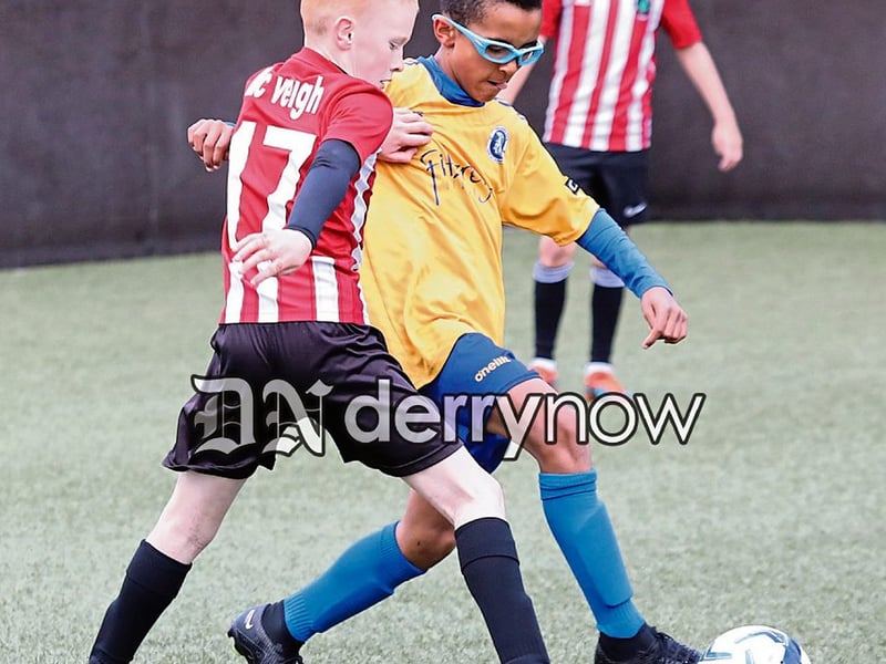Ballymoor v Trojans players in a tussle for possession in the Padraig Barton Cup.