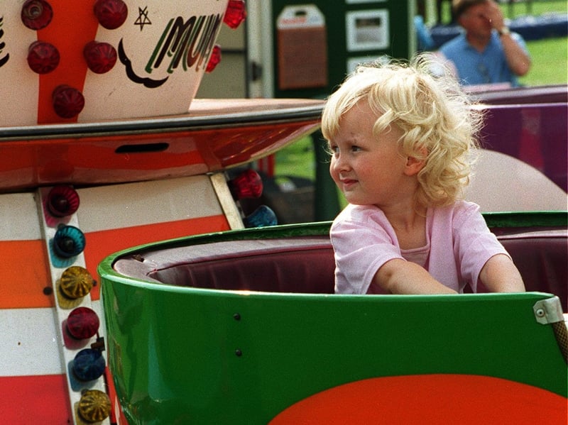 Anyone for tea? This little girl sits and waits for her turn in a giant tea cup.