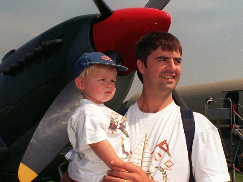Nineteen-month-old Fraser Timlin and his dad David survey the Leeds Show framed by the propeller of a Spitfire, one of the RAF's display aircraft at the show.