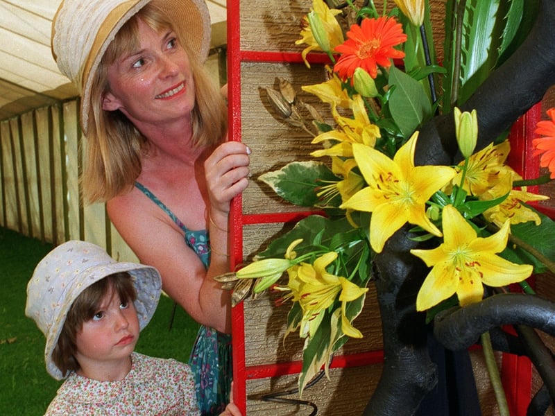 Moira Chippindale and her daughter Sally, five, from Oakwood, admire a floral display by Headingley Flower Club.
