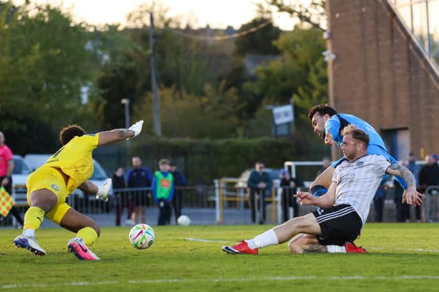 A sliding Stephen Walsh is just unable to get a touch on Ed McCarthy's 24th minute cross-cum-shot.