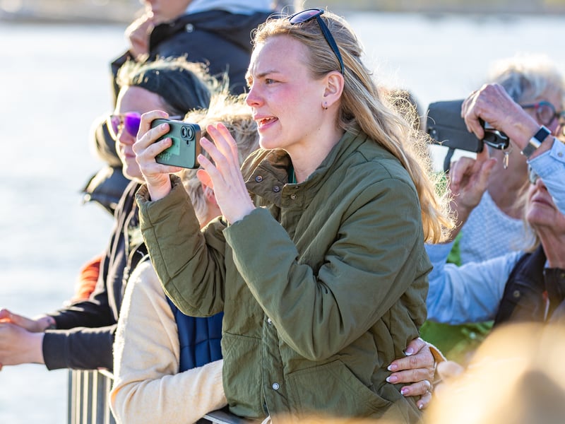 Emotional families and loved ones watching the ship's company.