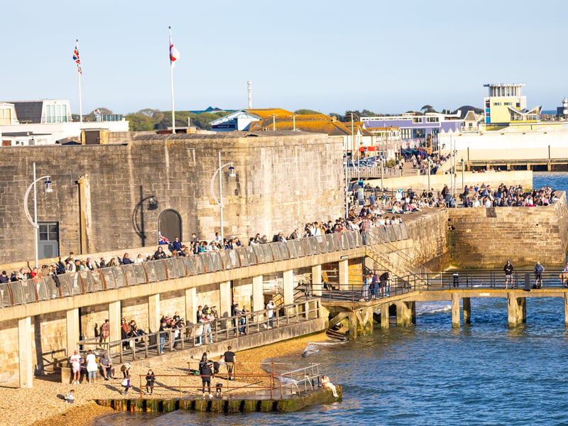Families lining The Hot Walls waiting to see HMS Prince of Wales.