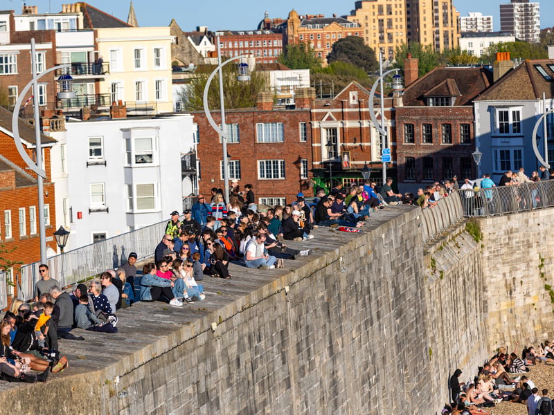 Families lining The Hot Walls waiting for HMS Prince of Wales.
